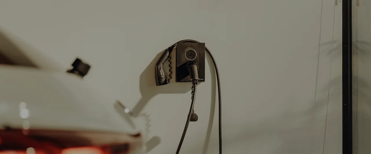 Wall-mounted EV charger installed in a garage; image from the supplied archive